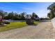 Landscaped backyard with shed and gravel driveway at 36323 Piney Ridge Blvd, Fruitland Park, FL 34731