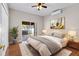 Bedroom with wood floors, sliding glass doors to patio, and neutral color scheme at 36323 Piney Ridge Blvd, Fruitland Park, FL 34731