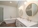 Spa-like bathroom with walk-in shower, soaking tub, and double vanity at 4216 Se 7Th Pl, Ocala, FL 34471