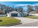 Modern home with white exterior, gray garage door, and driveway at 4216 Se 7Th Pl, Ocala, FL 34471