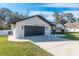 Stylish house with white exterior, gray garage door, and landscaping at 4216 Se 7Th Pl, Ocala, FL 34471