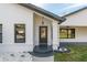 Dark gray front door with glass panels and a covered entryway at 4216 Se 7Th Pl, Ocala, FL 34471