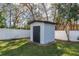 White storage shed with black door in backyard at 4216 Se 7Th Pl, Ocala, FL 34471