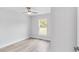 Simple bedroom with light gray walls, wood-look floors, and window at 4393 Sw 169 Lane Rd, Ocala, FL 34473