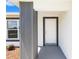Welcoming entryway with a white front door, gray trim, and textured walls, creating a bright and modern entrance at 4393 Sw 169 Lane Rd, Ocala, FL 34473