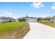 Charming single-story home featuring a gray and white exterior, a spacious driveway, and a well-manicured lawn at 4393 Sw 169 Lane Rd, Ocala, FL 34473