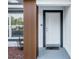 Detailed shot of the home's entrance featuring modern wood accents, a secure door, and a welcoming entryway at 4393 Sw 169 Lane Rd, Ocala, FL 34473