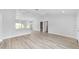 Open living space, featuring light gray walls and vinyl flooring at 4393 Sw 169 Lane Rd, Ocala, FL 34473