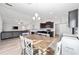 Bright dining area with farmhouse table and chairs, adjacent to kitchen at 4955 Se 89Th Place Rd, Ocala, FL 34480