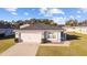 Inviting one-story home featuring a two-car garage and well-maintained lawn on a sunny day at 4955 Se 89Th Place Rd, Ocala, FL 34480