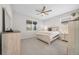 Bedroom with light wood platform bed, ceiling fan, and large windows at 5624 Sw 88Th Ave, Ocala, FL 34481