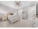 Bedroom with light wood platform bed, ceiling fan and en-suite bathroom at 5624 Sw 88Th Ave, Ocala, FL 34481