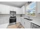 Modern kitchen with white cabinets, a stainless steel range, and double sink at 5624 Sw 88Th Ave, Ocala, FL 34481