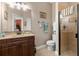 Bathroom with wood vanity and walk-in shower at 7451 Se 24Th Ter, Ocala, FL 34480