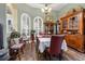 Elegant dining room featuring hardwood floors, a wood hutch, and a farm table at 7451 Se 24Th Ter, Ocala, FL 34480