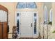 Entryway with wood coat rack, decorative plants, and white door at 7451 Se 24Th Ter, Ocala, FL 34480