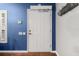 Inviting entryway with white door, blue walls, and wood floors at 7451 Se 24Th Ter, Ocala, FL 34480