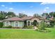 One-story home with a green exterior and manicured lawn at 7451 Se 24Th Ter, Ocala, FL 34480