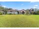 One-story house with manicured lawn and American flag at 7451 Se 24Th Ter, Ocala, FL 34480