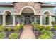 Front porch with stone columns, seating, and landscaping at 7451 Se 24Th Ter, Ocala, FL 34480