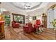 Relaxing living room with hardwood floors, red leather furniture, and a fireplace at 7451 Se 24Th Ter, Ocala, FL 34480