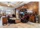 Living room with wood built-ins and a view into the kitchen at 7451 Se 24Th Ter, Ocala, FL 34480