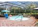 Inviting screened pool area with spa and brick pavers at 7451 Se 24Th Ter, Ocala, FL 34480