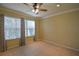 Bright bedroom with tile floors and ceiling fan at 8852 Se 119Th St, Summerfield, FL 34491