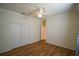 Bedroom with wood-look floors and double doors at 8852 Se 119Th St, Summerfield, FL 34491