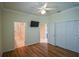 Bedroom with wood-look floors, a mounted TV, and access to two bathrooms at 8852 Se 119Th St, Summerfield, FL 34491