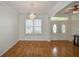 Bright dining room with hardwood floors, crown molding, and a chandelier at 8852 Se 119Th St, Summerfield, FL 34491