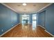 Blue-walled dining room with hardwood floors and a chandelier at 8852 Se 119Th St, Summerfield, FL 34491