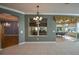 Bright dining room with chandelier and view to a sunroom at 8852 Se 119Th St, Summerfield, FL 34491