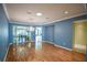 Blue-walled dining room with hardwood floors and a chandelier at 8852 Se 119Th St, Summerfield, FL 34491