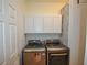 Laundry room with washer, dryer, cabinets, and shelving at 8852 Se 119Th St, Summerfield, FL 34491