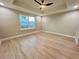 Bright bedroom with wood-look flooring and a ceiling fan at 8968 Se 156Th St, Summerfield, FL 34491