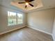 Spacious bedroom with large window and wood-look floors at 8968 Se 156Th St, Summerfield, FL 34491