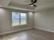 Bright bedroom with large window, hardwood floors, and ceiling fan at 8968 Se 156Th St, Summerfield, FL 34491