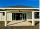 Covered patio with sliding glass doors and ceiling fan at 8968 Se 156Th St, Summerfield, FL 34491