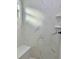 Modern shower with built-in bench and marble-look tile at 8968 Se 156Th St, Summerfield, FL 34491