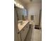 Well-lit bathroom features a single sink vanity, toilet, and walk-in shower at 9625 Sw 207Th Cir, Dunnellon, FL 34431