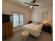 Cozy bedroom with neutral tones, a ceiling fan, and two windows for ample natural light at 9625 Sw 207Th Cir, Dunnellon, FL 34431