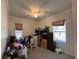 Bedroom featuring a ceiling fan and windows with a desk and shelves at 9625 Sw 207Th Cir, Dunnellon, FL 34431