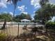 Fenced community pool with inviting pool house, lounge chairs, and beautiful landscaping at 9625 Sw 207Th Cir, Dunnellon, FL 34431