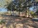 Exterior view of mobile home, featuring tall trees, and located in a private, wooded setting at 9625 Sw 207Th Cir, Dunnellon, FL 34431