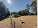 Scenic view of a home nestled in a serene landscape, with a fenced yard and mature trees, creating a private oasis at 9625 Sw 207Th Cir, Dunnellon, FL 34431