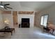 Bright living room featuring tile floors, ceiling fan, and abundant natural light at 9625 Sw 207Th Cir, Dunnellon, FL 34431