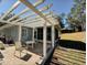 Covered patio with table and chairs, perfect for outdoor entertaining at 9625 Sw 207Th Cir, Dunnellon, FL 34431