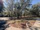 Landscaped lawn surrounded by mature trees and walking path at 9625 Sw 207Th Cir, Dunnellon, FL 34431