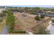 Aerial view of a fenced dog park with shaded seating in a planned residential community at 10129 Sw 77Th Loop, Ocala, FL 34481